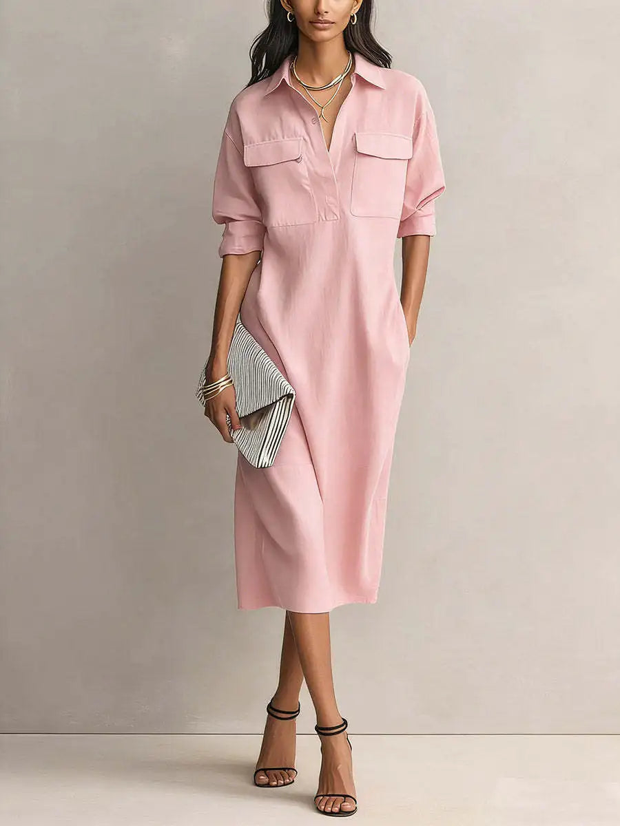 Pink - A woman wearing a light blue linen midi shirt dress with a collar, V-neckline, chest flap pockets, and half sleeves, styled with black strappy heels and a striped clutch.