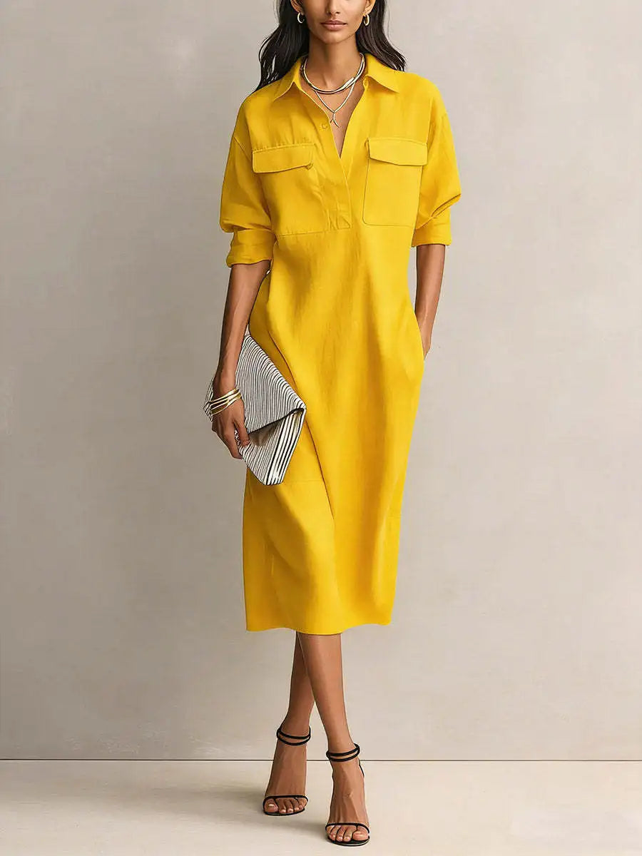 Yellow - A woman wearing a light blue linen midi shirt dress with a collar, V-neckline, chest flap pockets, and half sleeves, styled with black strappy heels and a striped clutch.