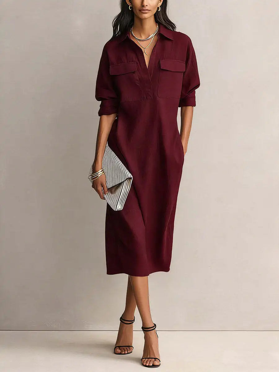 Red - A woman wearing a light blue linen midi shirt dress with a collar, V-neckline, chest flap pockets, and half sleeves, styled with black strappy heels and a striped clutch.