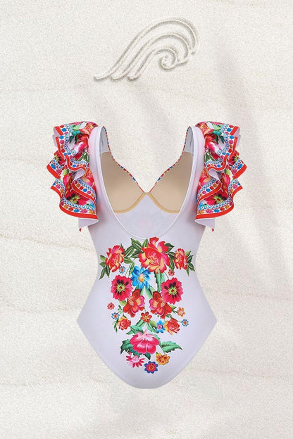 Woman in white floral print swimsuit with ruffled sleeves