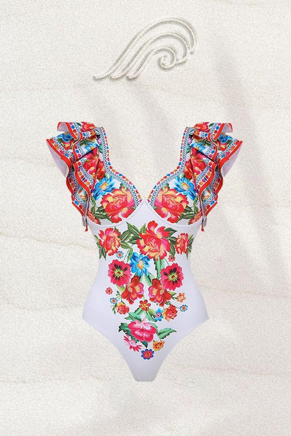 Woman in white floral print swimsuit with ruffled sleeves