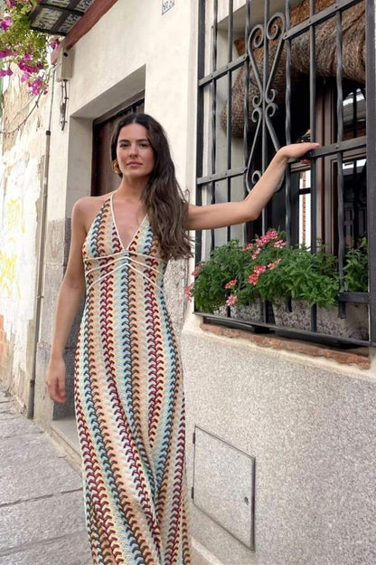 Woman in multi-color crochet knit halter maxi dress