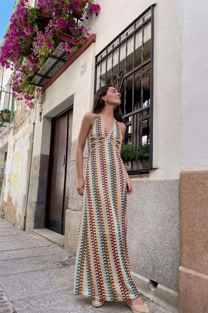 Woman in multi-color crochet knit halter maxi dress