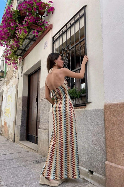 Woman in multi-color crochet knit halter maxi dress