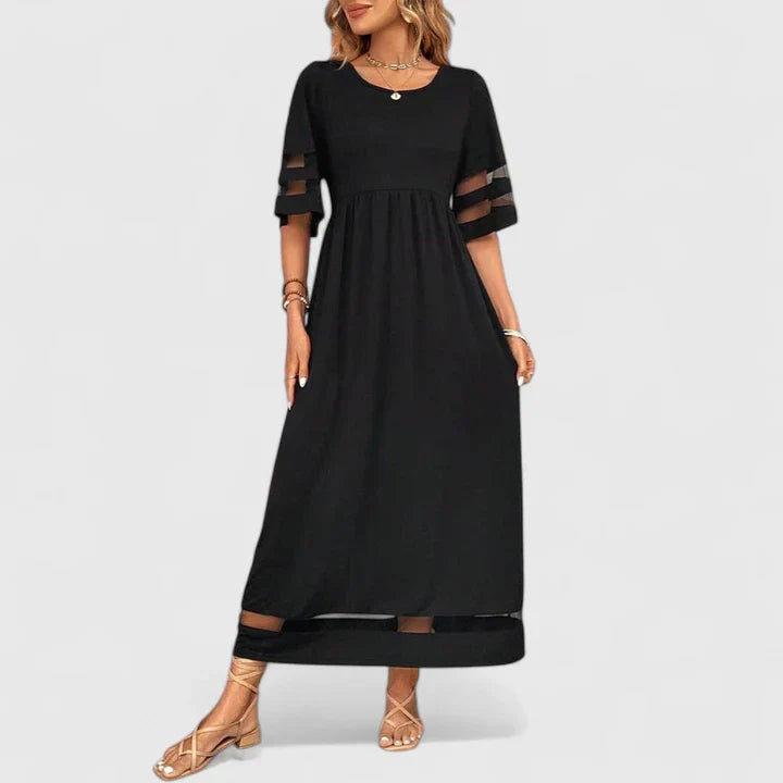 Black - A woman wearing a burgundy maxi dress with elbow-length sleeves and a scoop neckline, featuring sheer mesh stripe inserts on the sleeves and hem, styled with a straw hat and bag.
