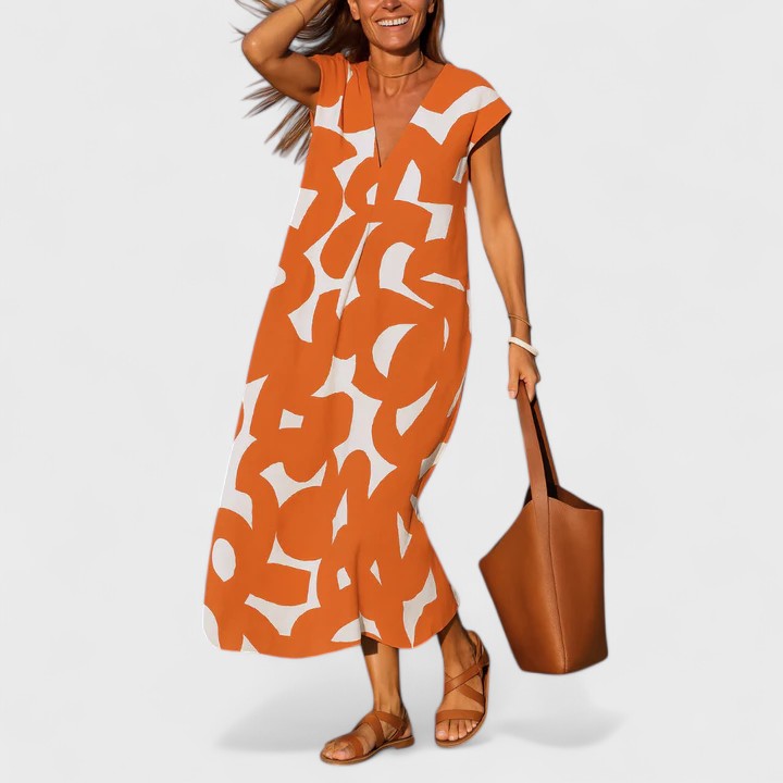 Orange - A woman wearing a black and white abstract graphic print midi dress with a V-neckline, cap sleeves, and a relaxed shift silhouette, styled with brown leather sandals and a shoulder bag.