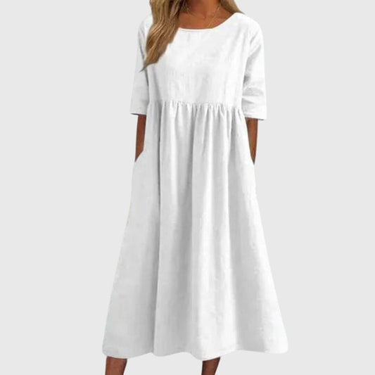 White - A woman wearing a solid white linen-blend midi dress with a scoop neckline, elbow-length half sleeves, a gathered empire waist, and a flowy skirt with side pockets.