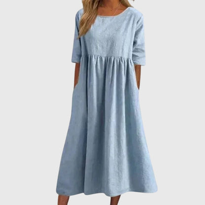Light Blue - A woman wearing a solid white linen-blend midi dress with a scoop neckline, elbow-length half sleeves, a gathered empire waist, and a flowy skirt with side pockets.