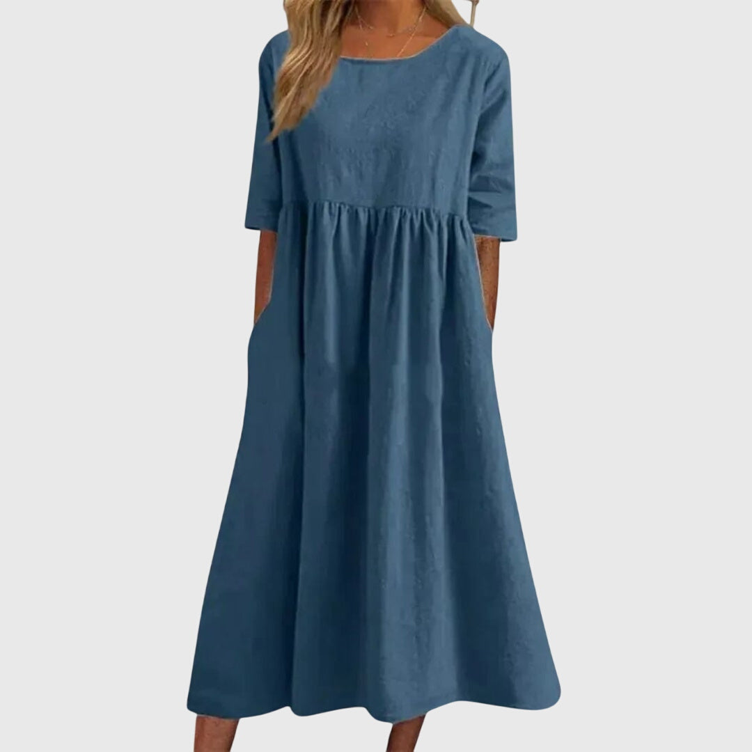 Blue - A woman wearing a solid white linen-blend midi dress with a scoop neckline, elbow-length half sleeves, a gathered empire waist, and a flowy skirt with side pockets.