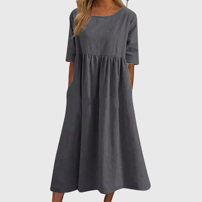 Gray - A woman wearing a solid white linen-blend midi dress with a scoop neckline, elbow-length half sleeves, a gathered empire waist, and a flowy skirt with side pockets.