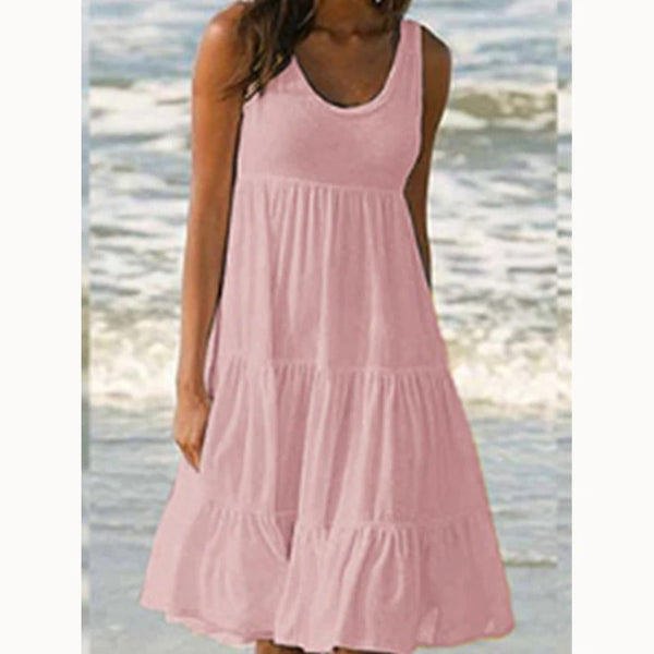 Pink - A woman wearing a sleeveless white cotton jersey tiered midi sundress with a scoop neckline and relaxed A-line silhouette.