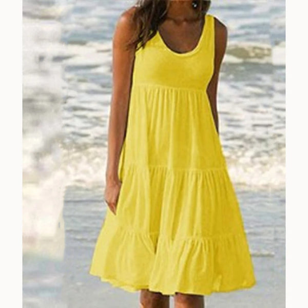 Yellow - A woman wearing a sleeveless white cotton jersey tiered midi sundress with a scoop neckline and relaxed A-line silhouette.