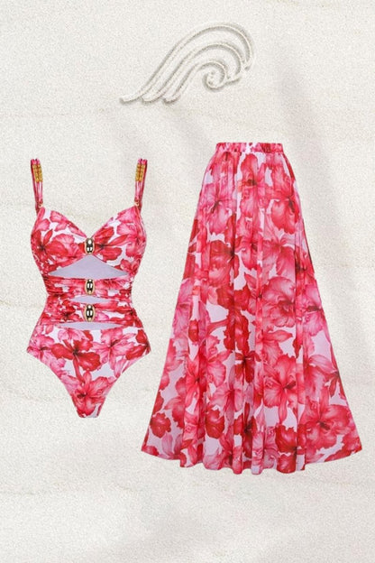 Woman in pink and red floral chiffon maxi dress with cutout waist.