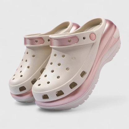 Khaki - Molded foam slip-on platform clogs featuring ventilation ports across the upper, a pivoting heel strap, and a distinct metallic trim along the thick midsole