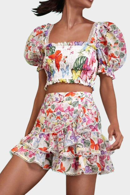 Woman wearing butterfly print crop top and ruffle skirt set