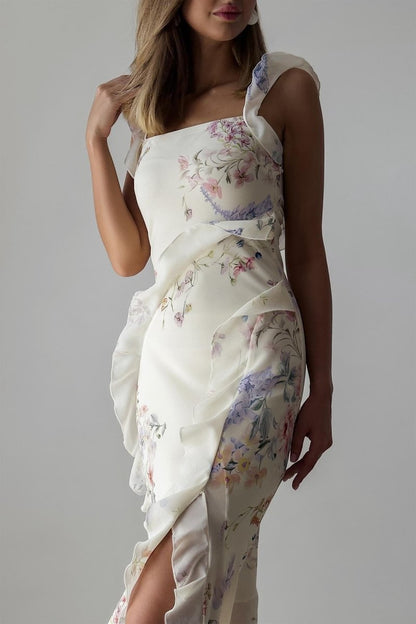 A woman wearing a floral chiffon dress with ruffles.