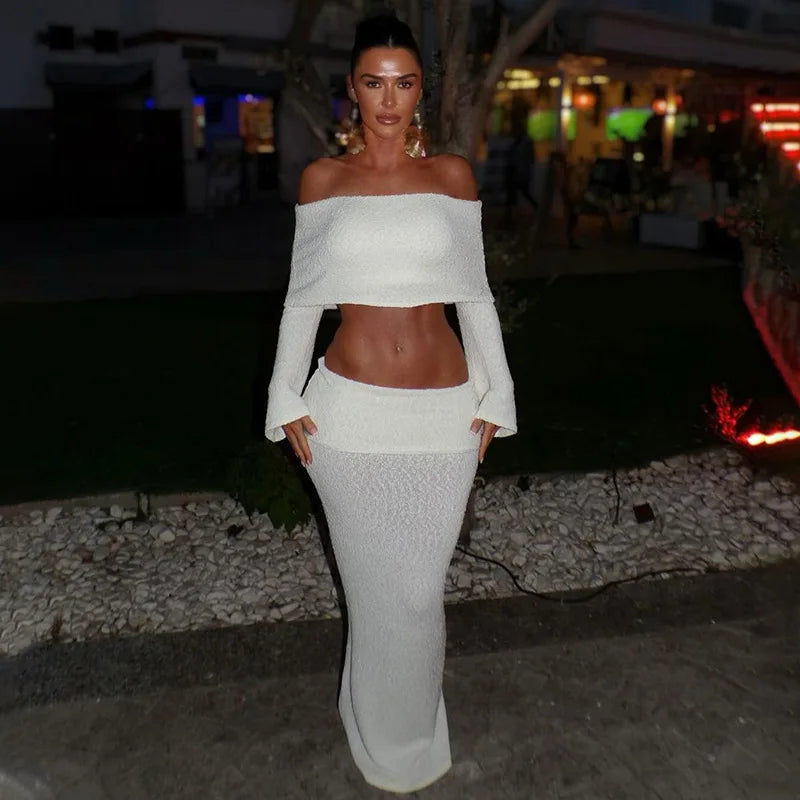 Woman in white boucle off-the-shoulder crop top and midi skirt set.