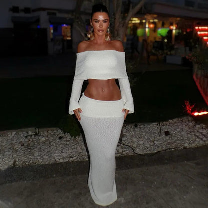 Woman in white boucle off-the-shoulder crop top and midi skirt set.