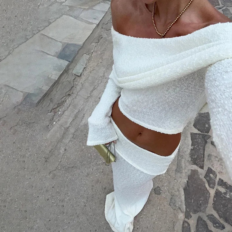 Woman in white boucle off-the-shoulder crop top and midi skirt set.