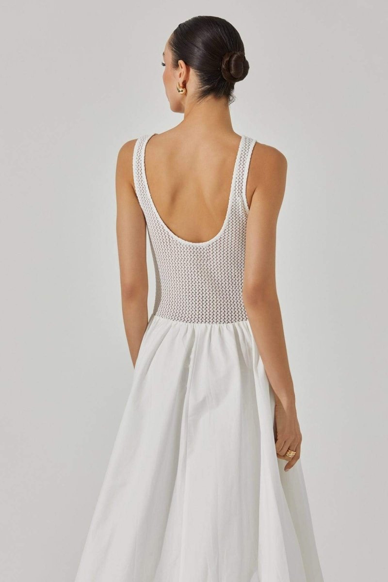 Woman in white crochet knit bodice dress