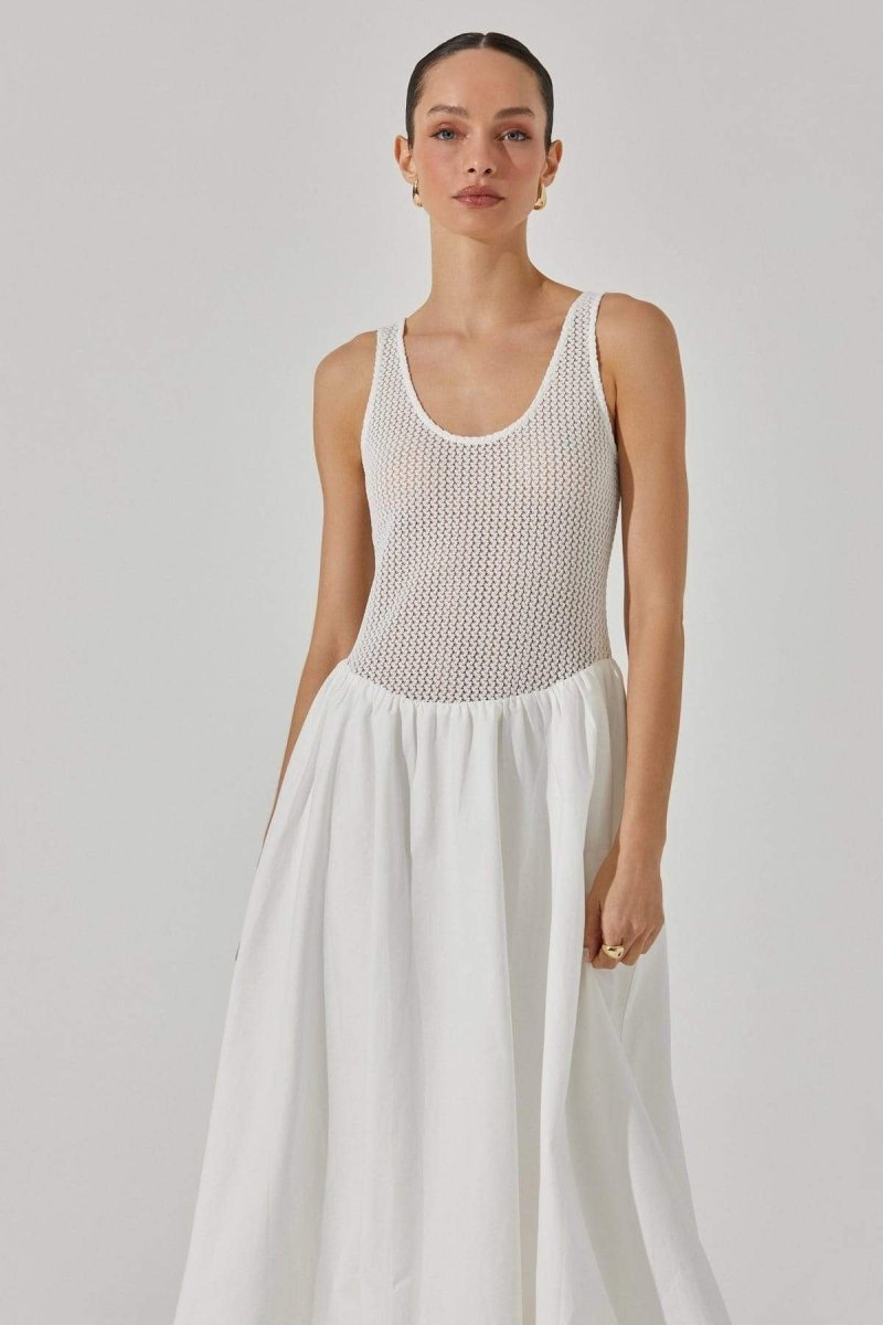 Woman in white crochet knit bodice dress