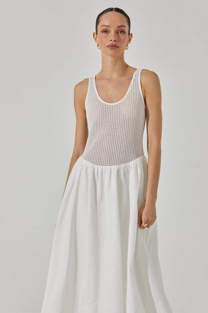 Woman in white crochet knit bodice dress