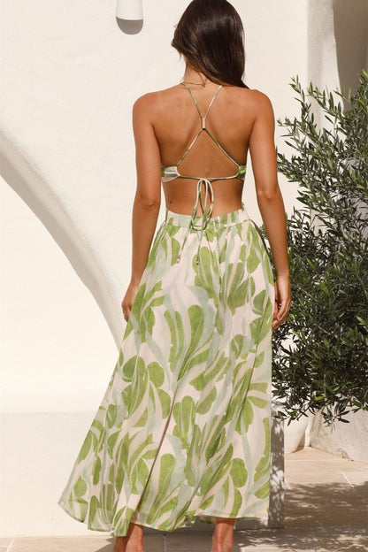 Woman in green and beige chiffon halter maxi dress with cutouts
