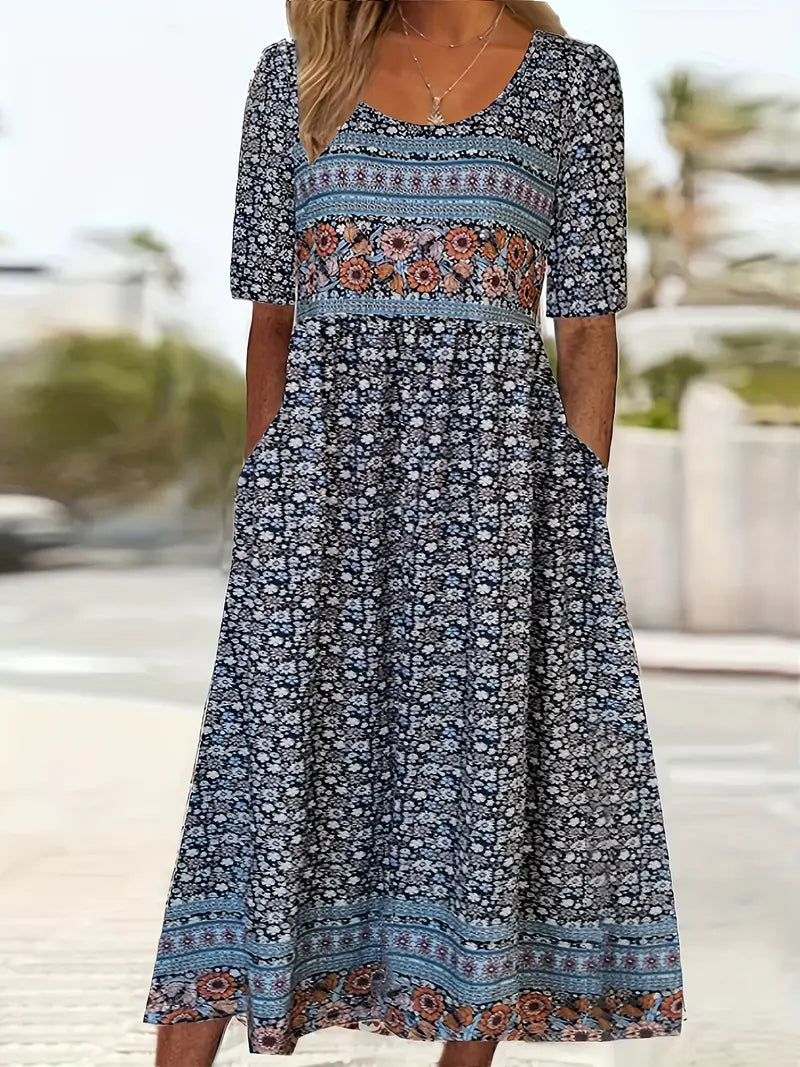 Multicolor1 - A woman wearing a bohemian-style maxi sundress featuring a multi-colored paisley and ditsy floral print, scoop neckline, half sleeves, and functional side pockets.