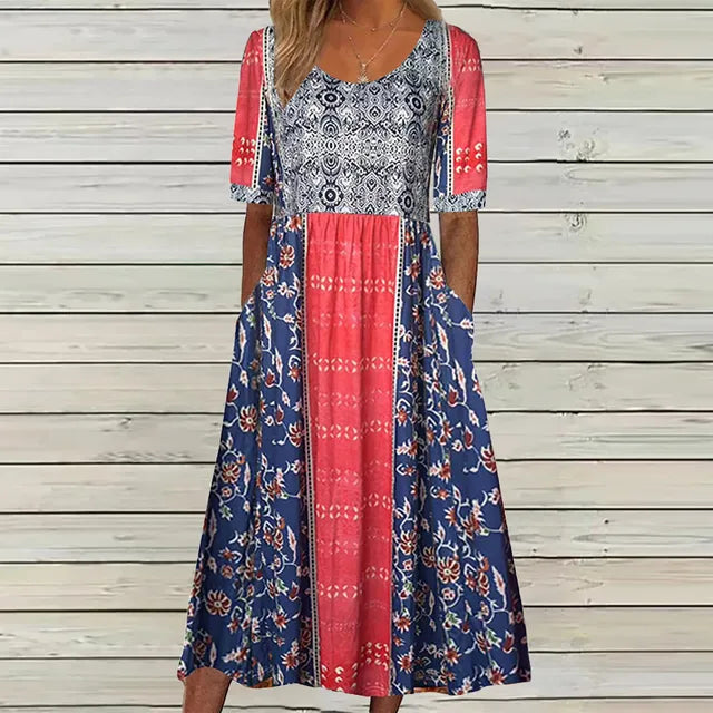 Multicolor3 - A woman wearing a bohemian-style maxi sundress featuring a multi-colored paisley and ditsy floral print, scoop neckline, half sleeves, and functional side pockets.