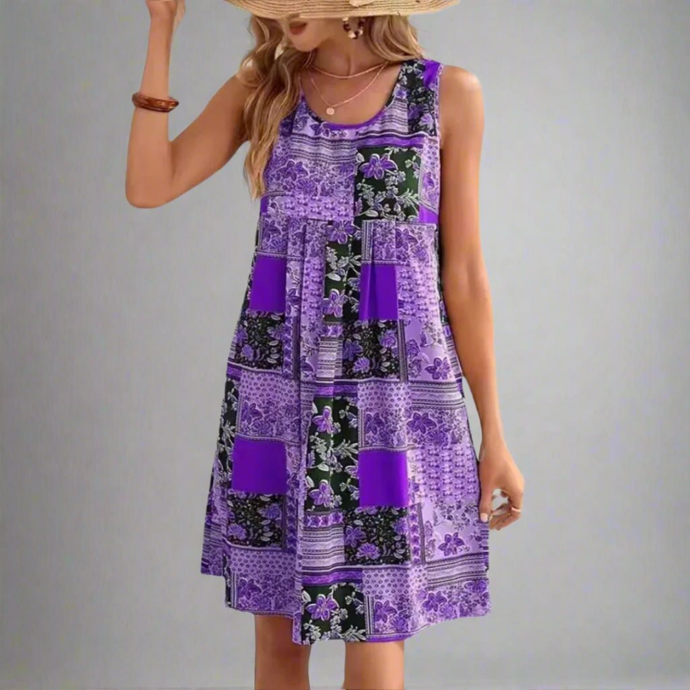 Purple - A woman wearing a sleeveless mini dress featuring a multi-colored patchwork floral print in orange, navy, and cream, styled with a scoop neckline and a gathered empire waist.