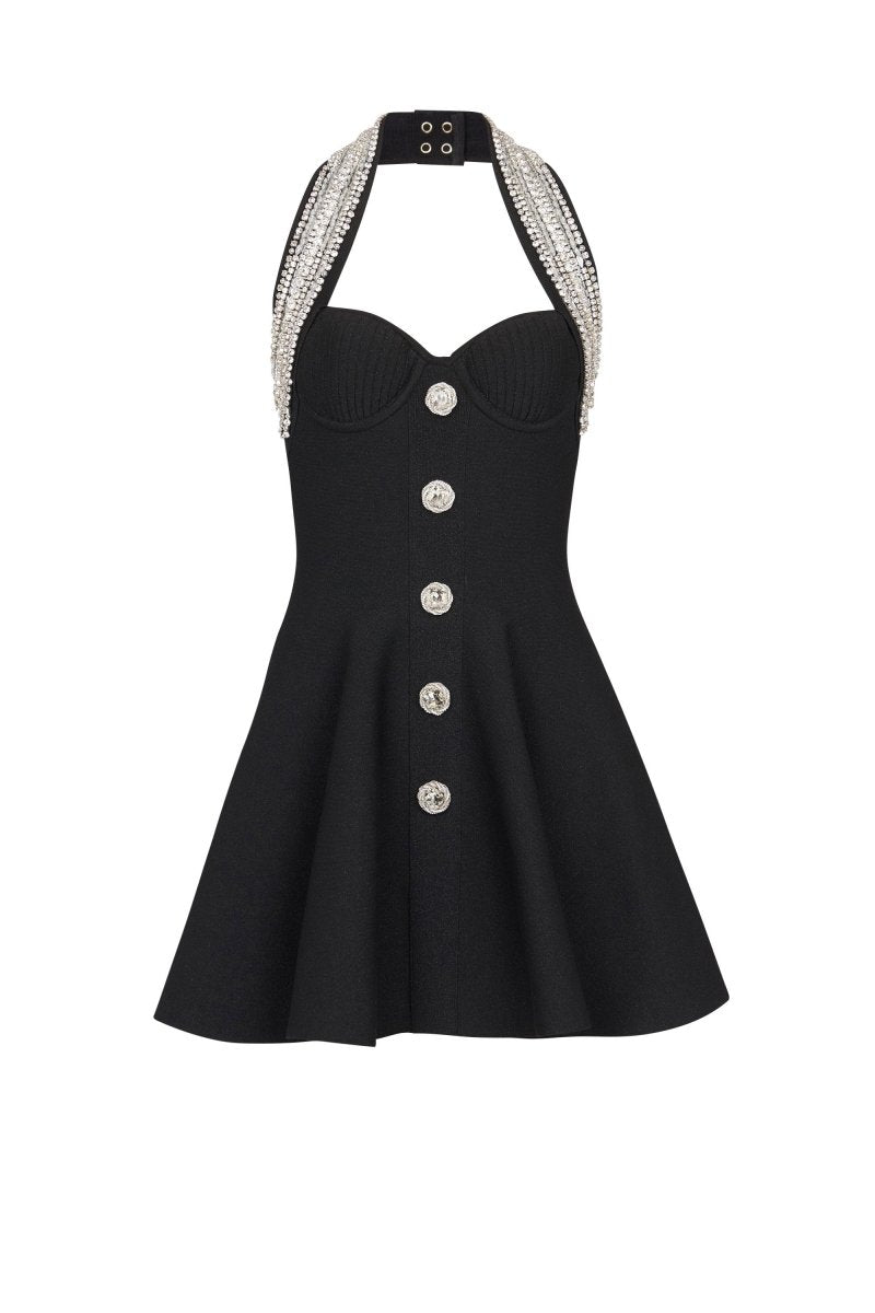 Woman wearing black mini dress with crystal halter neck and decorative buttons