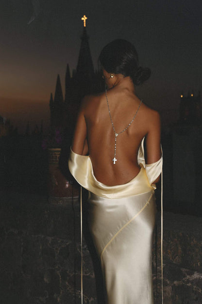 Woman wearing ivory silk cowl neck slip dress