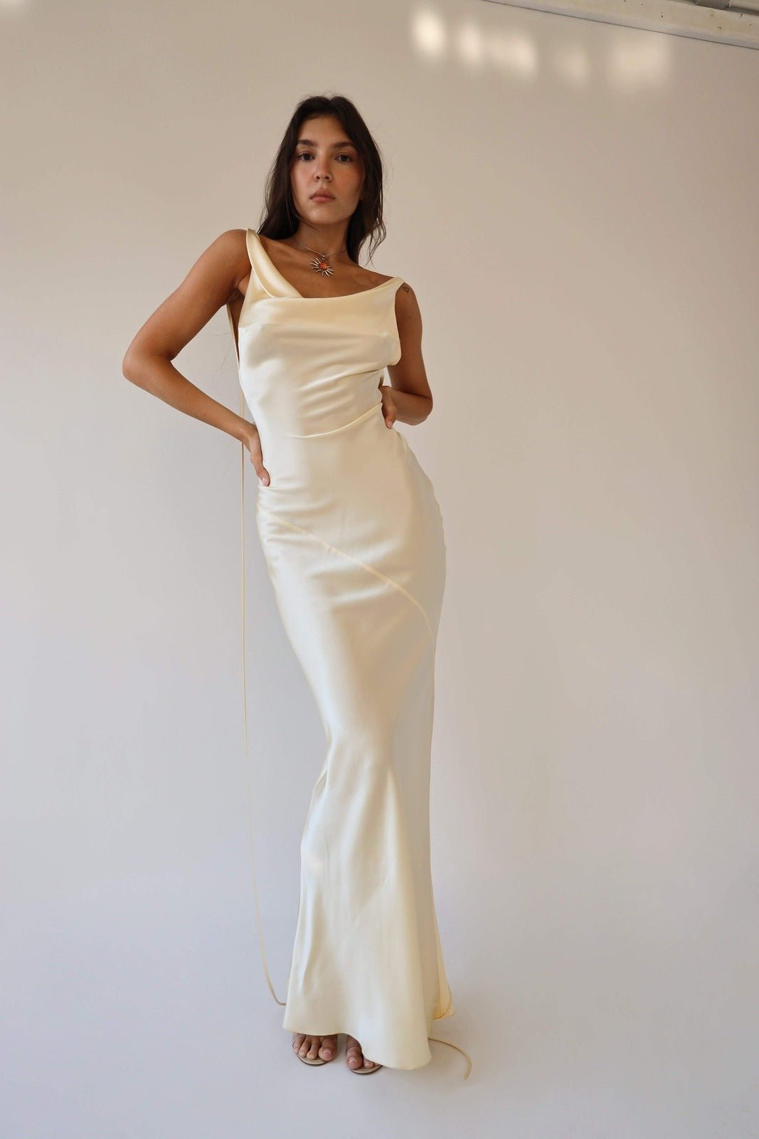 Woman wearing ivory silk cowl neck slip dress