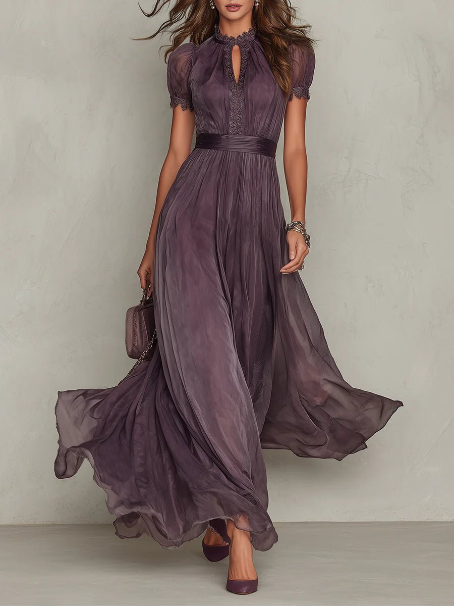 Purple - A woman wearing a flowing, deep mauve pleated chiffon maxi dress with a high keyhole neckline, lace-trimmed puff sleeves, and a banded waist.