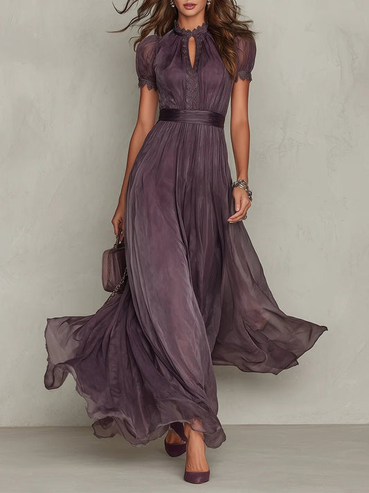 Purple - A woman wearing a flowing, deep mauve pleated chiffon maxi dress with a high keyhole neckline, lace-trimmed puff sleeves, and a banded waist.