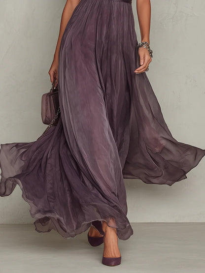 Purple - A woman wearing a flowing, deep mauve pleated chiffon maxi dress with a high keyhole neckline, lace-trimmed puff sleeves, and a banded waist.