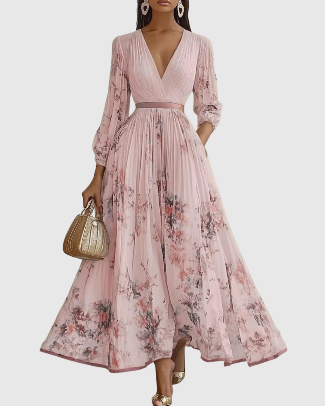 Pink - Model wearing a sleeveless, plunging V-neck midi dress in pleated off-white chiffon with a blue and gold watercolor floral print, featuring a cinched blue waist band and a flowy A-line skirt with pockets.