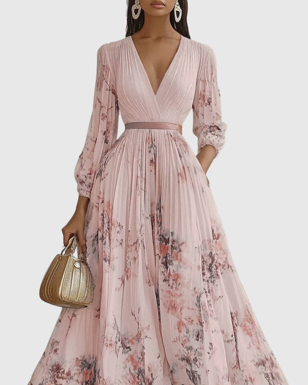 Pink - Model wearing a sleeveless, plunging V-neck midi dress in pleated off-white chiffon with a blue and gold watercolor floral print, featuring a cinched blue waist band and a flowy A-line skirt with pockets.