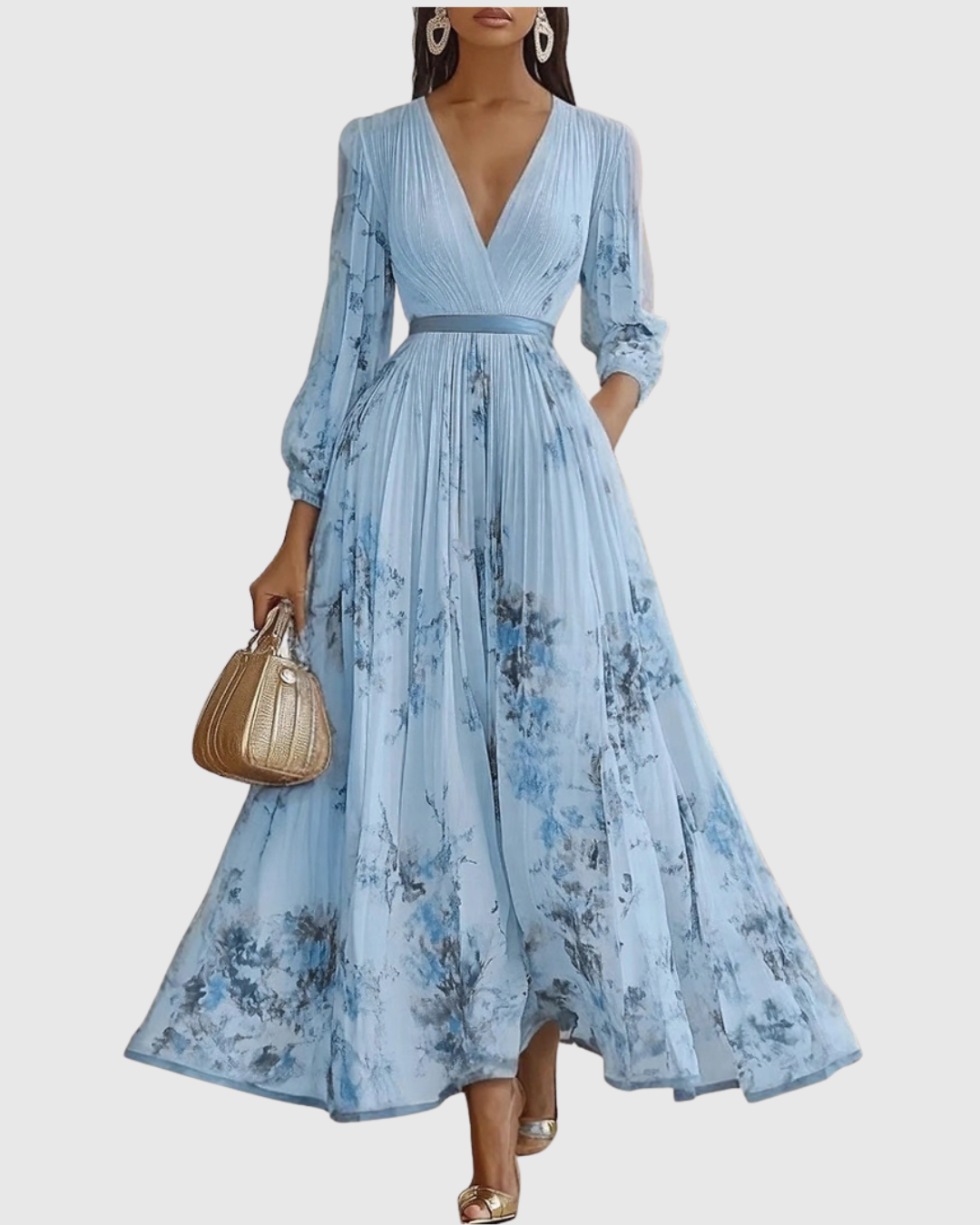 Blue - Model wearing a sleeveless, plunging V-neck midi dress in pleated off-white chiffon with a blue and gold watercolor floral print, featuring a cinched blue waist band and a flowy A-line skirt with pockets.