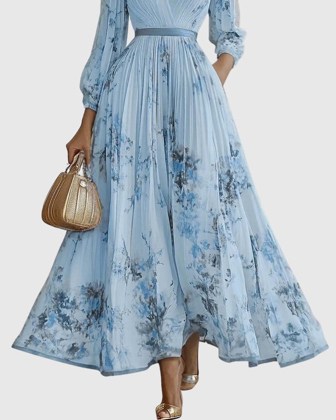Blue - Model wearing a sleeveless, plunging V-neck midi dress in pleated off-white chiffon with a blue and gold watercolor floral print, featuring a cinched blue waist band and a flowy A-line skirt with pockets.