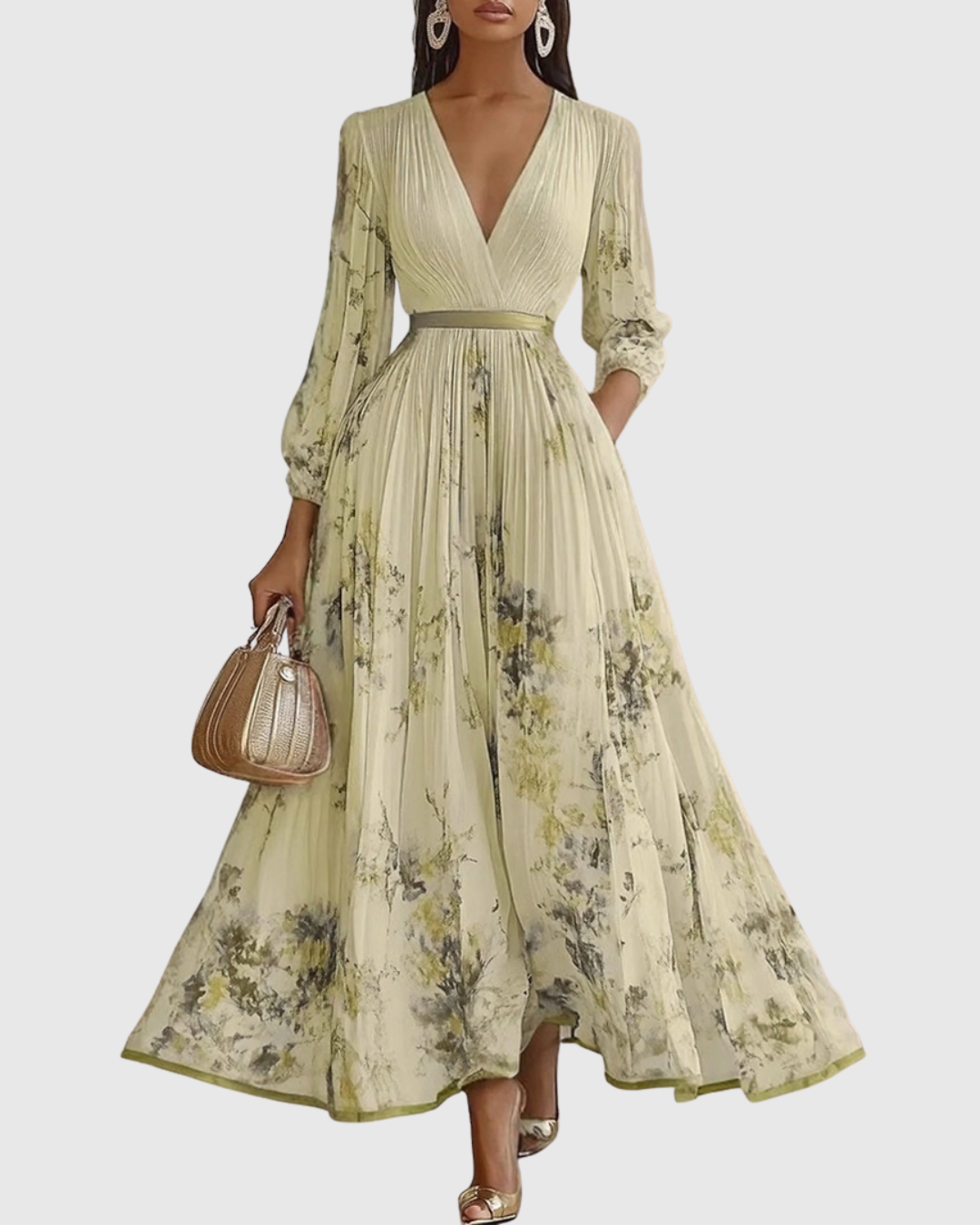 Yellow - Model wearing a sleeveless, plunging V-neck midi dress in pleated off-white chiffon with a blue and gold watercolor floral print, featuring a cinched blue waist band and a flowy A-line skirt with pockets.