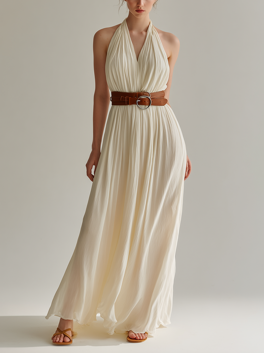 White - Sleeveless floor-length halter maxi dress in finely pleated fabric, styled with a double-wrap brown leather belt.