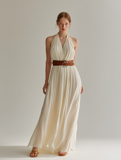 White - Sleeveless floor-length halter maxi dress in finely pleated fabric, styled with a double-wrap brown leather belt.