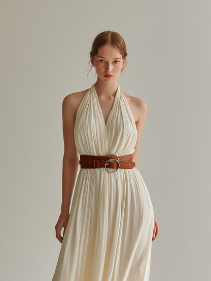 White - Sleeveless floor-length halter maxi dress in finely pleated fabric, styled with a double-wrap brown leather belt.