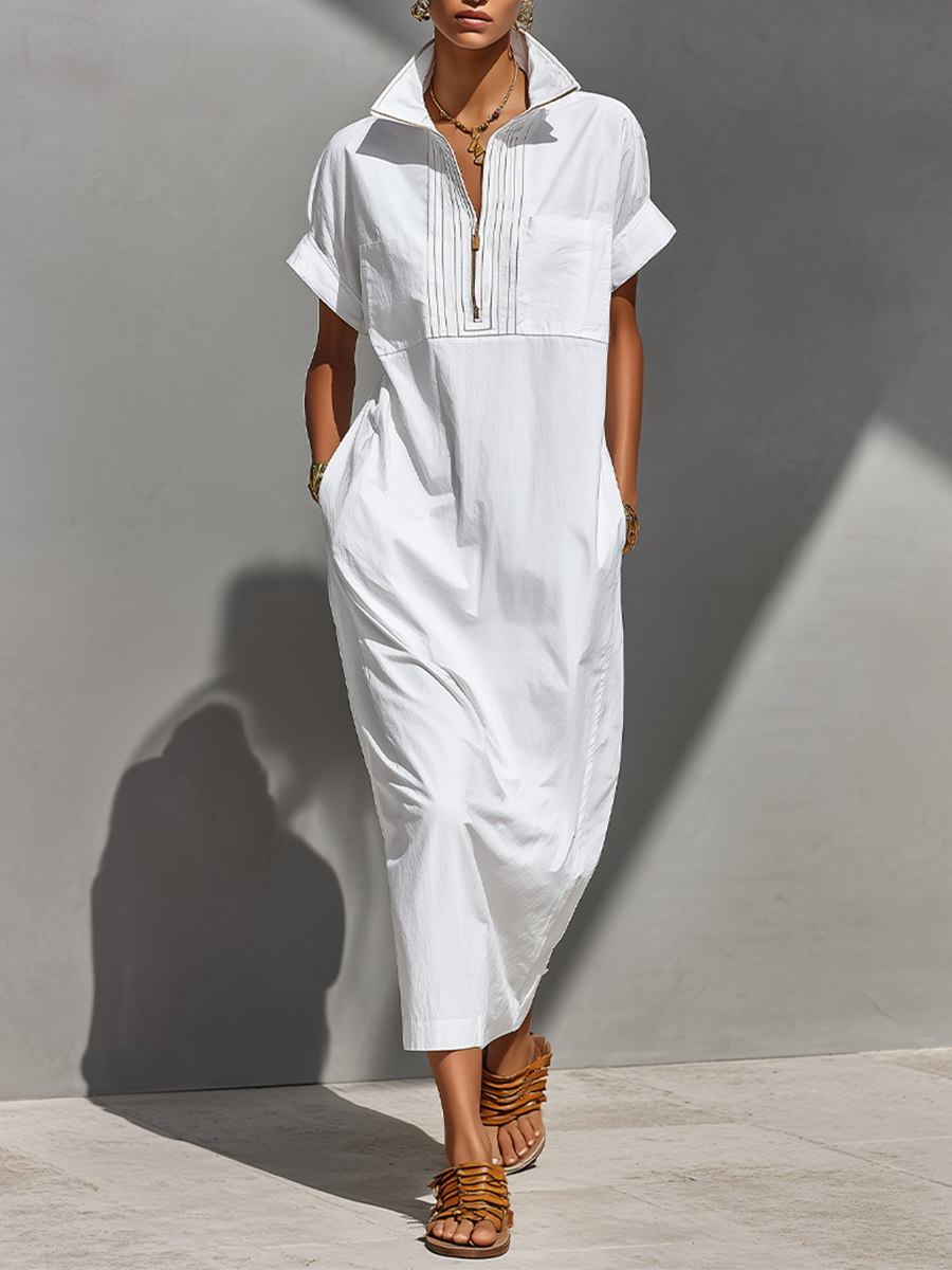White - Model walking outdoors wearing a crisp, relaxed-fit maxi shirtdress with a stand collar, short sleeves, and front half-zipper detail.
