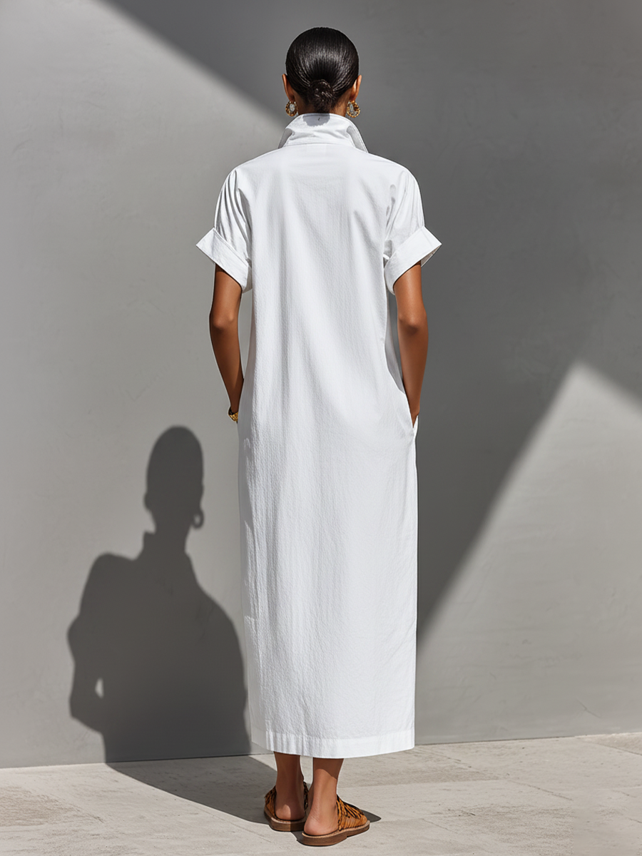 White - Model walking outdoors wearing a crisp, relaxed-fit maxi shirtdress with a stand collar, short sleeves, and front half-zipper detail.