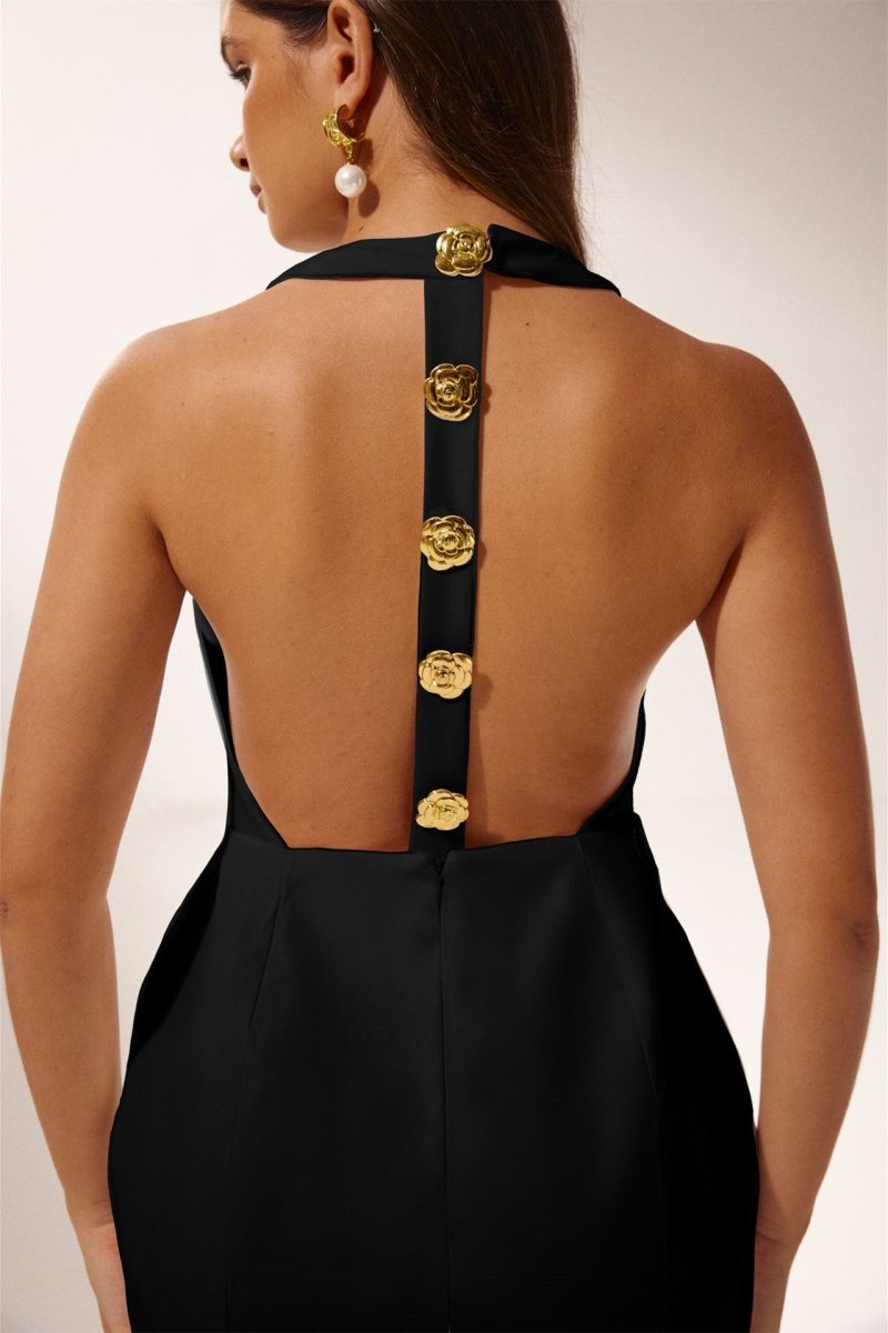 Woman in pink crepe mini dress with gold rose buttons