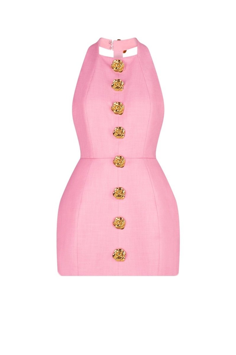 Woman in pink crepe mini dress with gold rose buttons