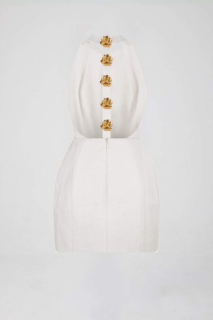 Woman in pink crepe mini dress with gold rose buttons