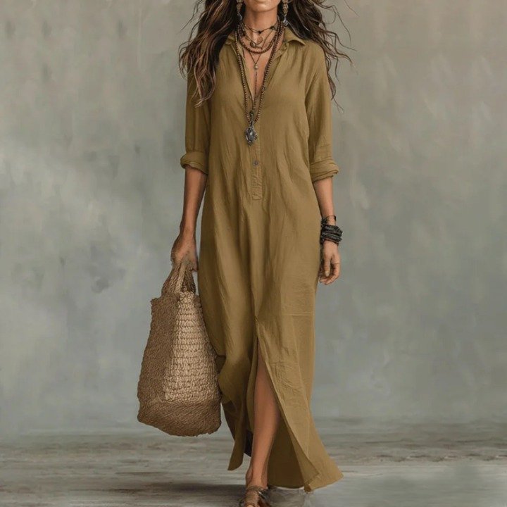 Khaki - A woman wearing a relaxed-fit white linen maxi sundress with a pointed collar, button placket, and front slit, carrying a woven straw bag.